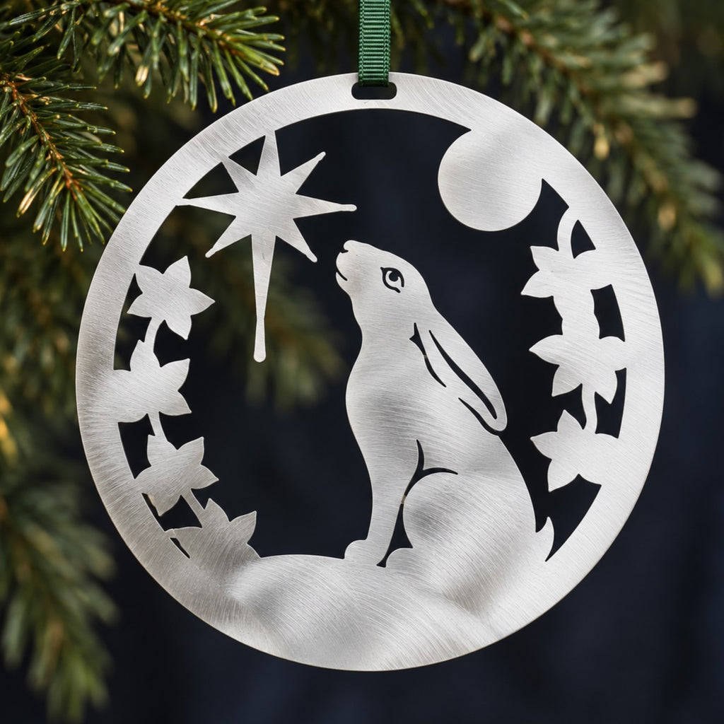 Stainless steel Christmas Hare hanging among understated evergreen Christmas foliage