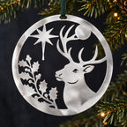 Stainless steel Christmas Stag hanging beside understated evergreen Christmas foliage
