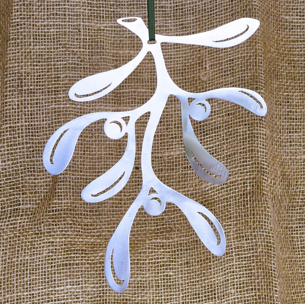 Stainless steel mistletoe decoration against a hessian background