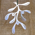 Stainless steel mistletoe decoration against a hessian background