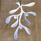 Stainless steel mistletoe decoration against a hessian background