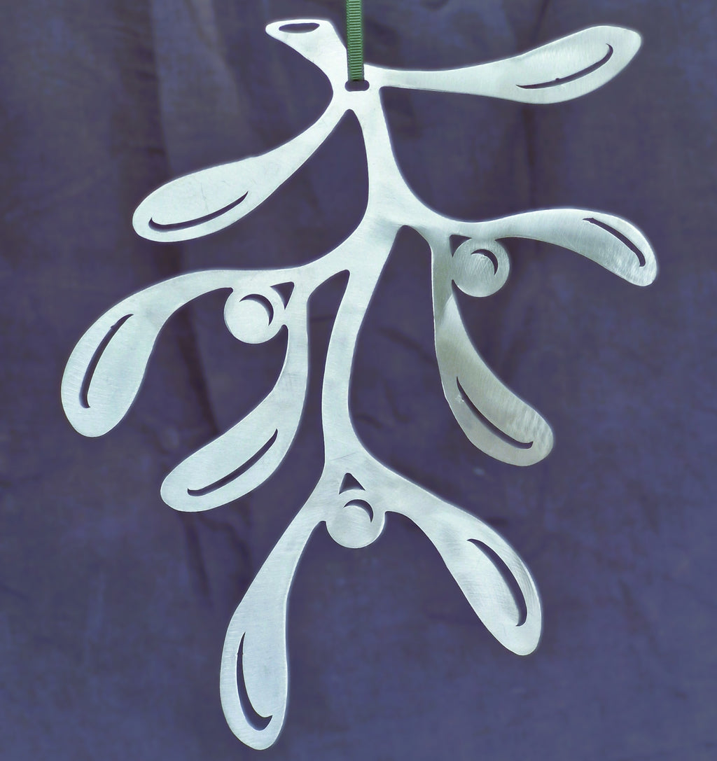 Polished silver Mistletoe Christmas ornament against a dark navy background