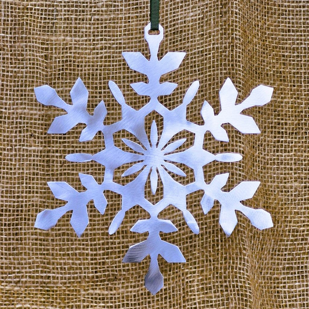 Large stainless steel Christmas Snowflake decoration on natural hessian