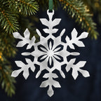 Stainless steel Snowflake hanging with understated evergreen Christmas foliage
