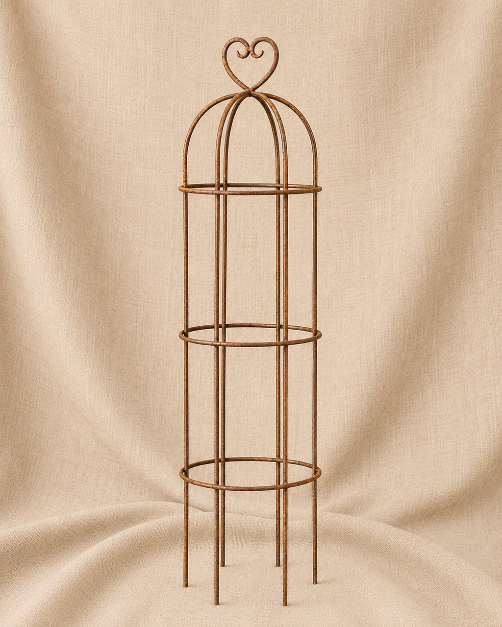 Classic Round Obelisk with Heart Top, handcrafted steel garden obelisk for supporting climbing plants, displayed on a natural hessian background by Dolton Designs.