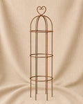 Classic Round Obelisk with Heart Top, handcrafted steel garden obelisk for supporting climbing plants, displayed on a natural hessian background by Dolton Designs.